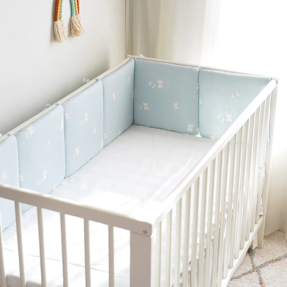 Tour de lit bébé bleu à motif d'éléphants fixé à un lit